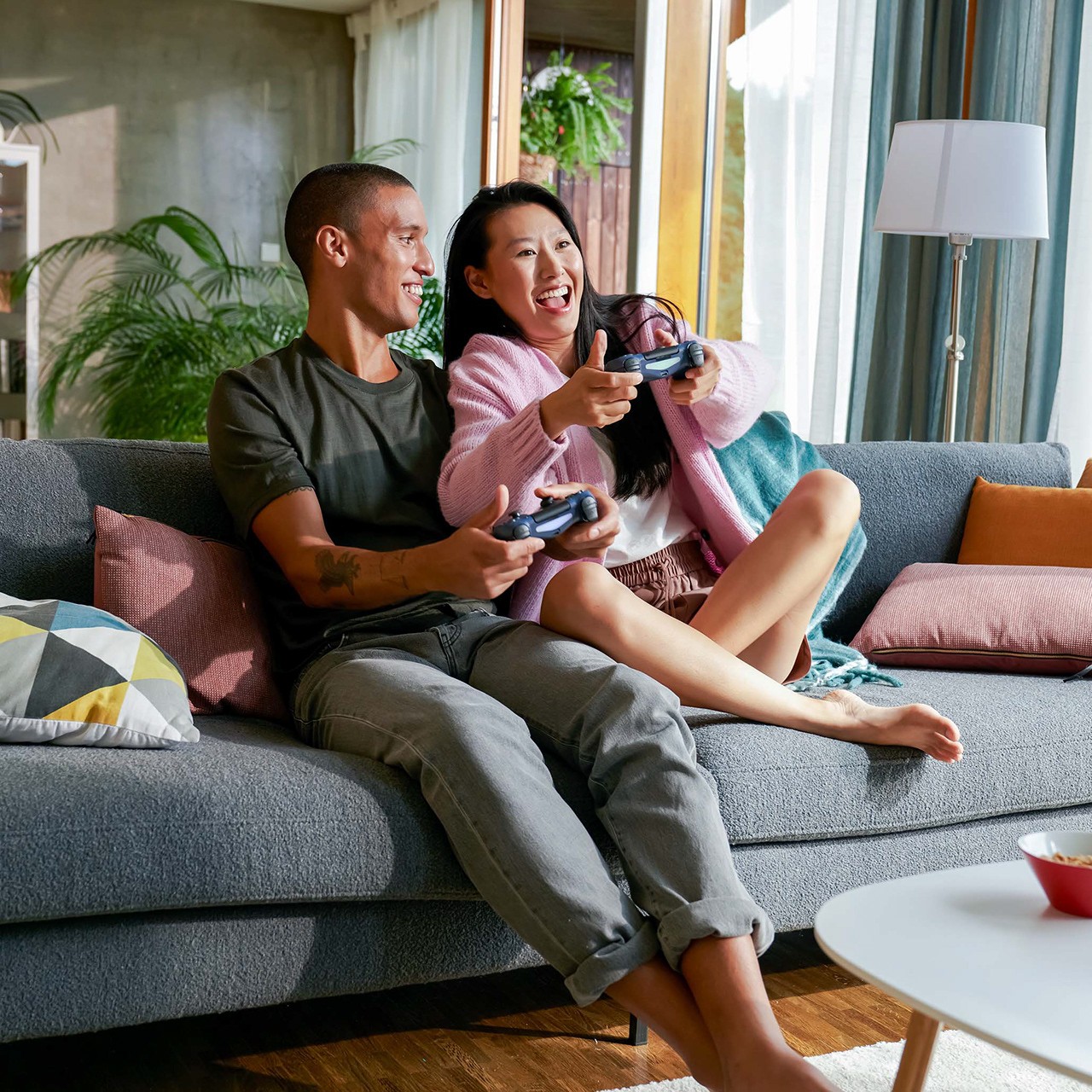 An eharmony couple laughing together while playing a game